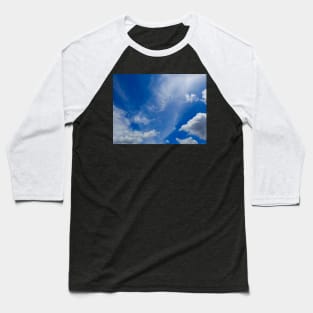 Fluffy white cloud shapes at blue sky. Baseball T-Shirt